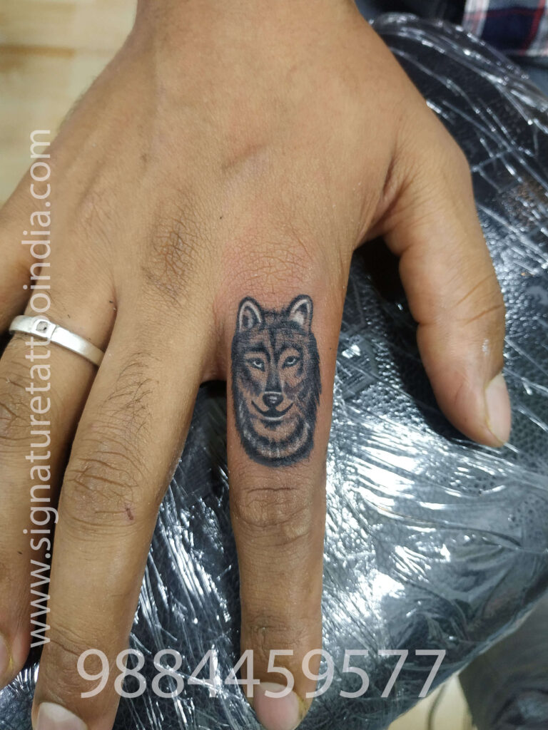 WOLF tattoo on finger