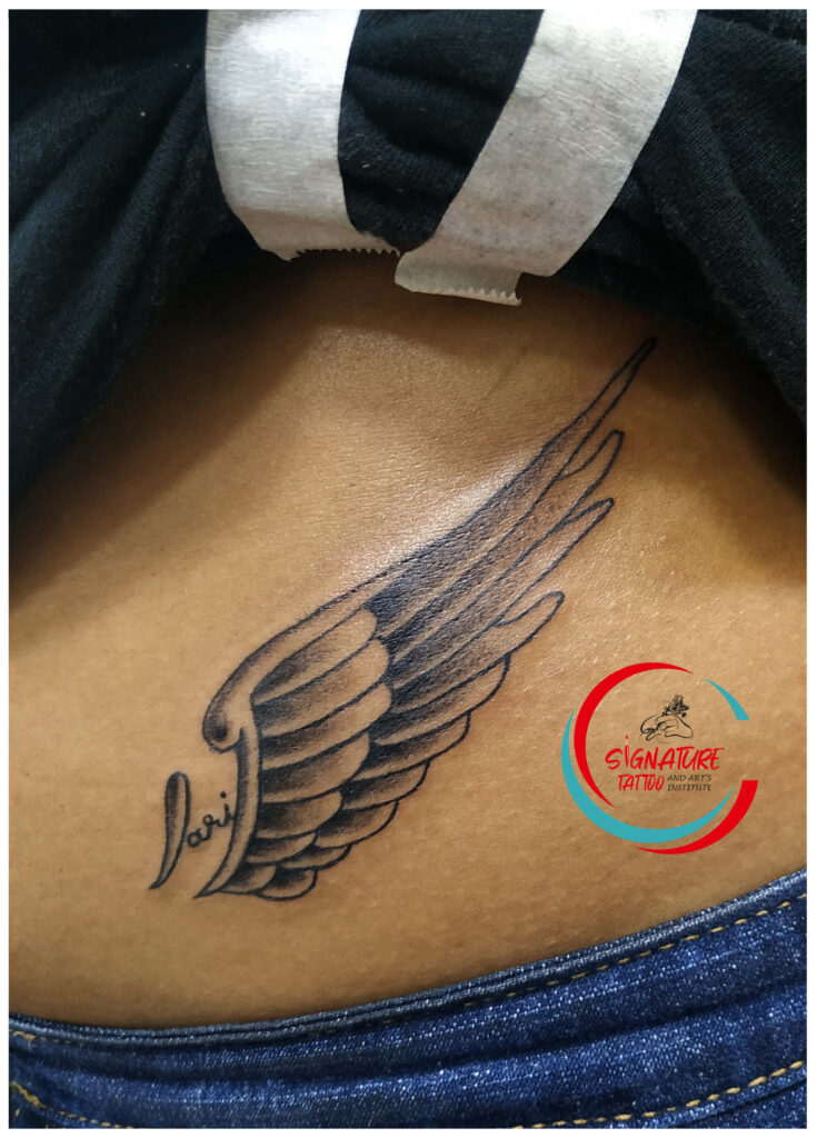 wings tattoo on hip